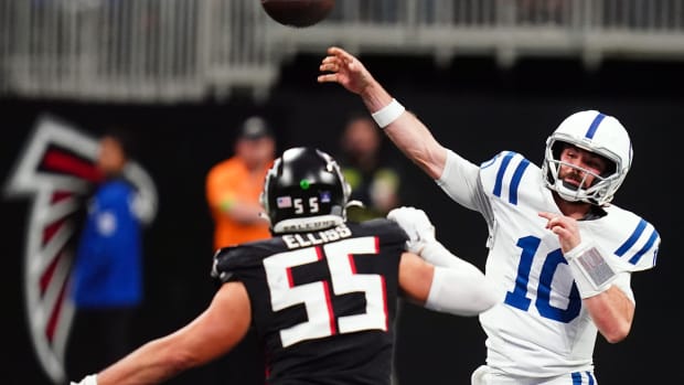 Indianapolis Colts quarterback Gardner Minshew (10) passing under pressure from Atlanta Falcons linebacker Kaden Elliss (55) during the second half at Mercedes-Benz Stadium.